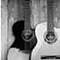 A black and white image of two guitars